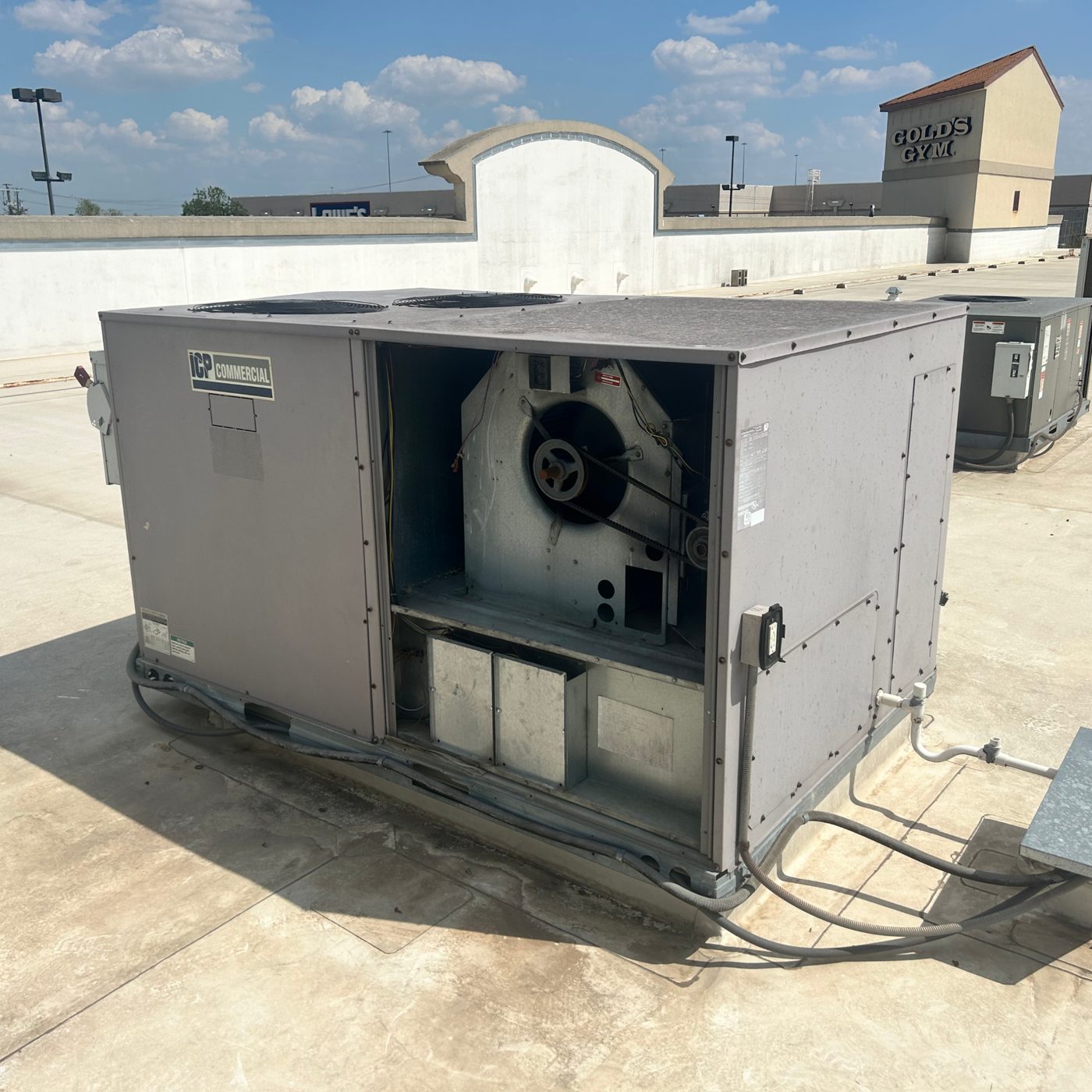 Airstrike HVAC servicing a commercial rooftop package unit in Central Texas